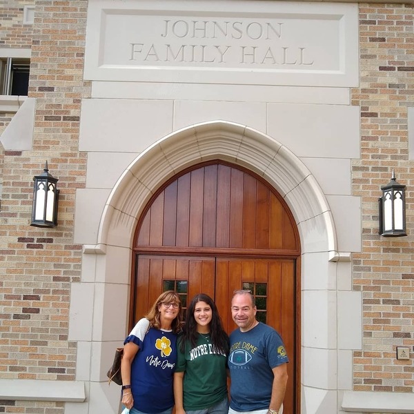 A Notre Dame student poses with parents at Junior Parents Weekend.