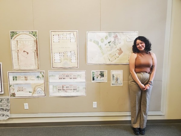 Myldred Hernandez-Gonzalez poses with work from the School of Architecture.