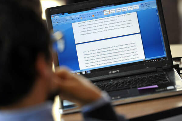 A student is reading over his admissions essay draft.