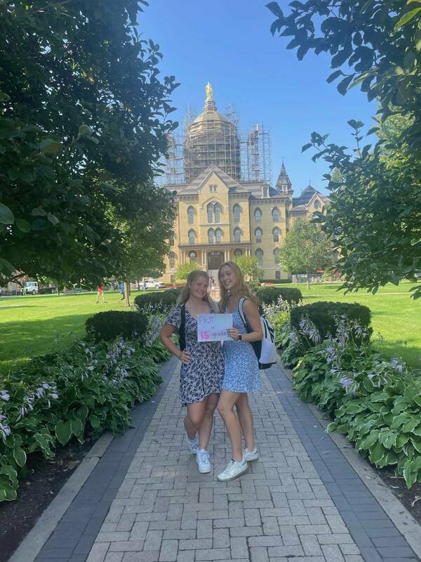 Two students pose in front of Notre Dame Main Building on the first day of class.