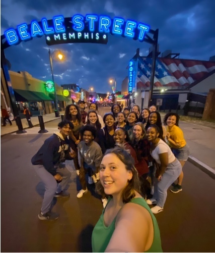A group of Notre Dame students pose together in front the Beale Street Memphis sign.