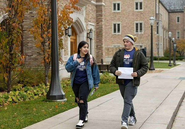 A Notre Dame mentor and a Talent Search student walk to class as part of 