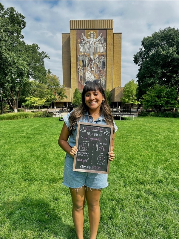 Lulu Romero '24 stands in front of the World of Life mural on her first day of class senior year.