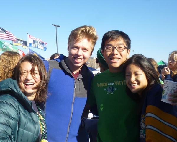 Zachary Koh '26 stands with a group of friends at a Notre Dame tailgate.