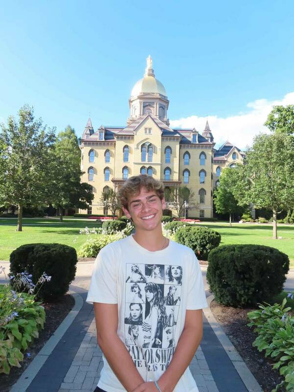 Sly Marona ‘27 in front of the Main Building wearing Eras Tour merch